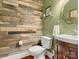 Unique bathroom with wood-plank accent wall and modern vanity at 12835 Cadgwith Cove Dr, Huntersville, NC 28078