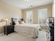 Bright bedroom with double windows and a dresser at 12835 Cadgwith Cove Dr, Huntersville, NC 28078