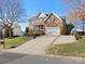 Brick two-story house with a long driveway and landscaping at 12835 Cadgwith Cove Dr, Huntersville, NC 28078