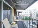 Covered balcony with seating overlooking the parking lot and buildings at 1323 Queens Rd # 407, Charlotte, NC 28207