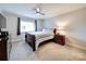 Cozy bedroom with ceiling fan and built-in shelving at 1323 Queens Rd # 407, Charlotte, NC 28207