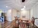 Bright dining area with wood floors and charming table set at 1323 Queens Rd # 407, Charlotte, NC 28207