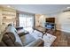 Relaxing living room with hardwood floors, gray sectional sofa, and built-in shelving at 1323 Queens Rd # 407, Charlotte, NC 28207