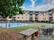 Inviting community pool with surrounding patio furniture at 1323 Queens Rd # 407, Charlotte, NC 28207