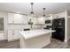 Modern kitchen with white cabinets, quartz countertops, and stainless steel appliances at 139 Elysian Dr, Mooresville, NC 28117