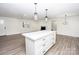 White kitchen island with quartz countertop, offering extra prep space at 139 Elysian Dr, Mooresville, NC 28117