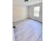 Simple bedroom with gray vinyl plank flooring and a window at 1460 23Rd Sw St, Hickory, NC 28602