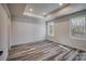 A light-filled bedroom with wood-look floors, neutral walls, and two large windows at 1460 23Rd Sw St, Hickory, NC 28602