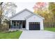 Charming house with gray and white siding, black garage door, and a well-manicured lawn at 1460 23Rd Sw St, Hickory, NC 28602