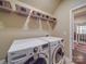 Bright laundry room features washer, dryer, and ample storage shelving at 156 Carmen Way, Lancaster, SC 29720