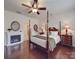 Main bedroom with fireplace and a four-poster bed at 156 Carmen Way, Lancaster, SC 29720