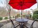 Private patio with table, chairs, and red umbrella at 156 Carmen Way # 70, Lancaster, SC 29720