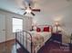 Cozy bedroom with hardwood floors, a ceiling fan, and a black metal bed frame at 156 Carmen Way, Lancaster, SC 29720