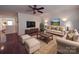 Bright living room with hardwood floors, stylish furniture, and a ceiling fan at 156 Carmen Way, Lancaster, SC 29720