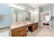 Bathroom boasts double sinks, large mirror, and access to bedroom at 15604 Wynford Hall St, Huntersville, NC 28078