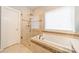 Bathroom features a walk-in shower and a relaxing bathtub at 15604 Wynford Hall St, Huntersville, NC 28078