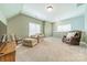 Spacious bonus room with two comfy chairs and a large TV at 15604 Wynford Hall St, Huntersville, NC 28078