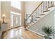 Bright entryway with hardwood floors, featuring a staircase and front door at 15604 Wynford Hall St, Huntersville, NC 28078