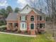 Brick two-story house with a large front yard and landscaping at 15604 Wynford Hall St, Huntersville, NC 28078