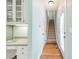 Bright hallway with hardwood floors and staircase at 15604 Wynford Hall St, Huntersville, NC 28078