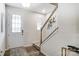 Front entry with white door, stairs, and wood-look flooring at 1709 Honey Trl, Monroe, NC 28112