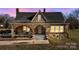 Charming stone house exterior at dusk, showing illuminated windows at 200 Church Dr, Shelby, NC 28150