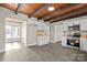 Modern kitchen with white cabinets, wood beam ceiling, and stainless steel appliances at 200 Church Dr, Shelby, NC 28150