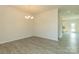 Bright dining room with chandelier and gray vinyl plank flooring, view into kitchen at 2238 Catawba Trace Dr, Catawba, NC 28609