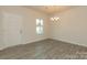 Bright dining room with chandelier and gray vinyl plank flooring, view of front door at 2238 Catawba Trace Dr, Catawba, NC 28609