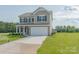 Two-story house with gray siding, white garage door, and a landscaped lawn with sprinkler system at 2238 Catawba Trace Dr, Catawba, NC 28609