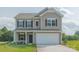 Two-story house with gray siding, a white garage door, and a landscaped lawn at 2238 Catawba Trace Dr, Catawba, NC 28609