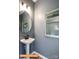 Modern powder room with pedestal sink, oval mirror, and gray walls at 2246 Catawba Trace Dr, Catawba, NC 28609