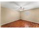 Spacious bedroom with hardwood floors and a ceiling fan at 232 14Th Se Ave # E, Hickory, NC 28502