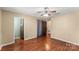 Bedroom with hardwood floors, ceiling fan and access to bathroom and closet at 232 14Th Se Ave # E, Hickory, NC 28502