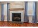 Brick fireplace in living room with wood mantel at 232 14Th Se Ave # E, Hickory, NC 28502