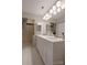 Bright bathroom with double sink vanity, white cabinets, and neutral tile flooring for a clean, modern look at 2502 Cranbrook Ln # 4, Charlotte, NC 28207