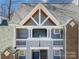 Close-up of a three story condo with a roofline apex, exterior accents and landscaping at 2502 Cranbrook Ln # 4, Charlotte, NC 28207