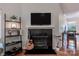 Living room featuring fireplace, guitar, shelving, and television at 2502 Cranbrook Ln # 4, Charlotte, NC 28207