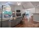 Cozy living room with a fireplace, vaulted ceilings, natural light, and an adjacent dining area and kitchen at 2502 Cranbrook Ln # 4, Charlotte, NC 28207