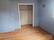 Bedroom with blue walls, wood floors, and closet at 2518 Cove Creek Dr, Gastonia, NC 28056