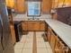 L-shaped kitchen with wood cabinets and tile floor at 2518 Cove Creek Dr, Gastonia, NC 28056