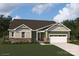 One-story home with green and beige siding, stone accents, and a two-car garage at 2526 Crimson Way, Monroe, NC 28112