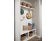 White mudroom with built-in bench, shelves, and hooks for bags and hats at 2526 Crimson Way, Monroe, NC 28112