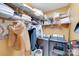 Well-equipped laundry room with washer, dryer, and ample shelving at 2706 White Pines Ct, Monroe, NC 28112