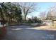 Gravel backyard with playground and wooden fence at 2912 Park Rd, Charlotte, NC 28209