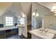 Elegant bathroom with soaking tub, double sinks, and large mirror at 2912 Park Rd, Charlotte, NC 28209