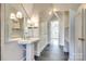 Bathroom with pedestal sink, tiled floor and built-in shelving at 2912 Park Rd, Charlotte, NC 28209