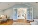 Spacious bedroom with hardwood floors and French doors leading to sitting area at 2912 Park Rd, Charlotte, NC 28209