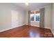 Well-lit bedroom featuring hardwood floors and ample natural light at 2912 Park Rd, Charlotte, NC 28209