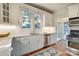 Modern white kitchen with stainless steel appliances and subway tile at 2912 Park Rd, Charlotte, NC 28209